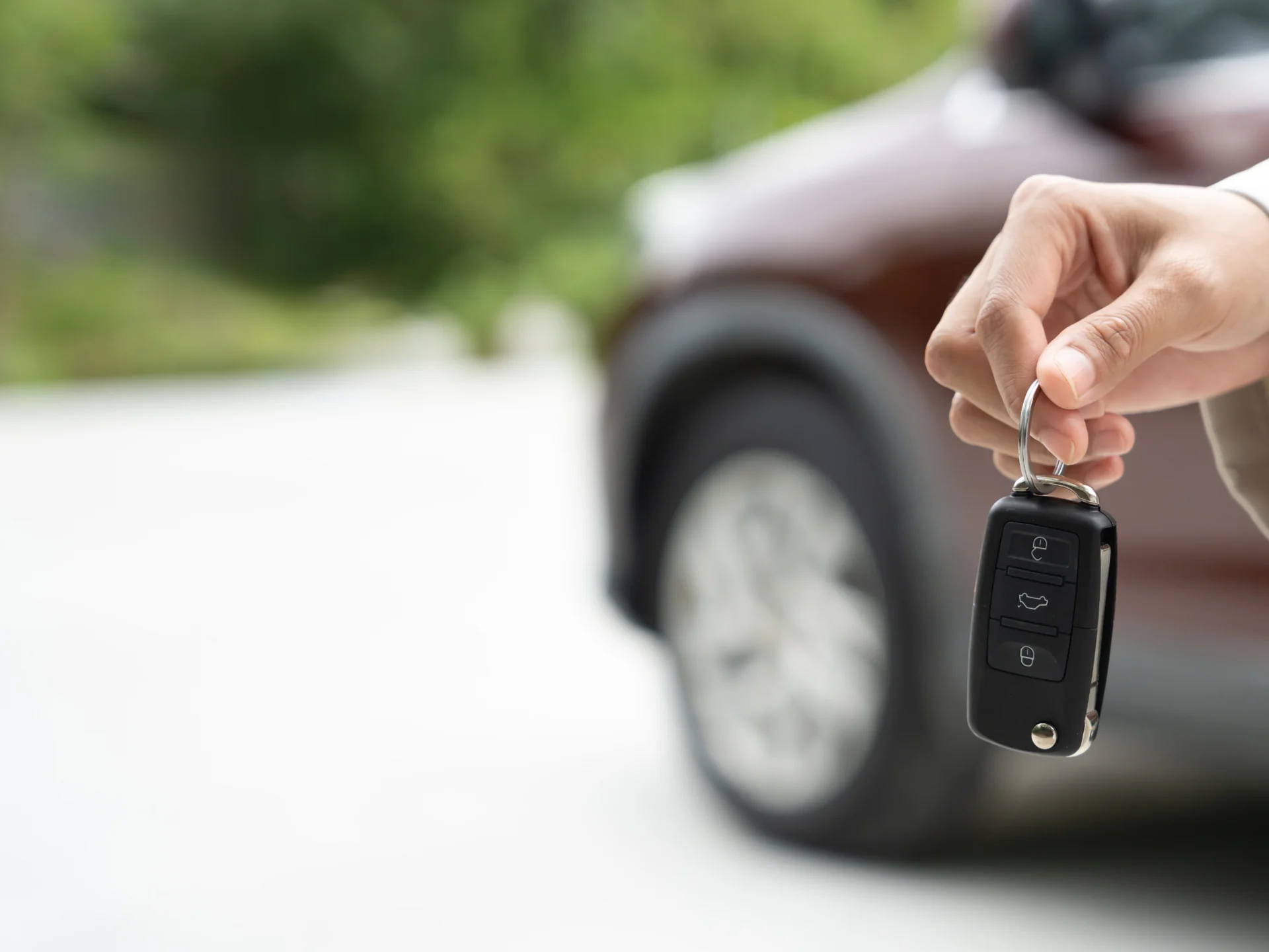 Handing the car key to a customer for a short-term rental